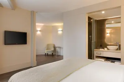 a bedroom with a bed and a bathroom with a sink at AC Hotel Istanbul Macka in Istanbul