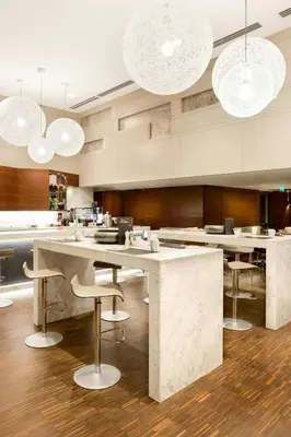 a kitchen with a large island with bar stools at AC Hotel Istanbul Macka in Istanbul