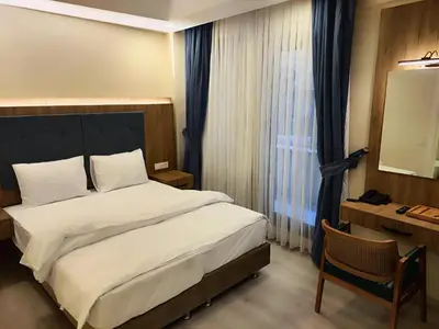 a hotel room with a bed and a desk and a bed sidx sidx at Hotel Esve Istanbul in Istanbul