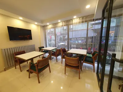 a restaurant with tables and chairs and a large window at Hotel Esve Istanbul in Istanbul