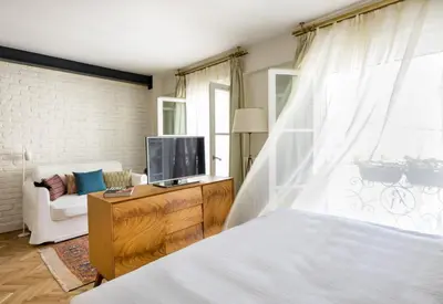 a bedroom with a bed and a tv and a couch at Pera Neuf in Istanbul