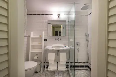 a white bathroom with a sink and a toilet at Pera Neuf in Istanbul