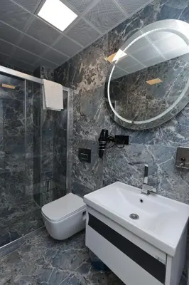 a bathroom with a sink and a toilet and a mirror at Sareban Hotel Istanbul in Istanbul