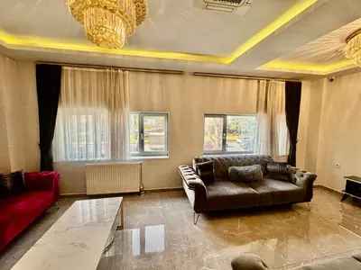 a living room with a leather couch and a table at Aram Edessa Hotel in Istanbul