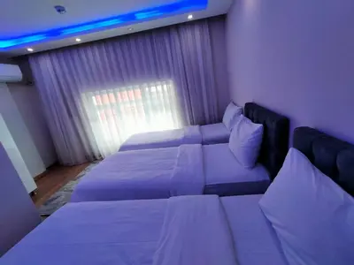 a hotel room with two beds and a couch at BlueRoyal Grand Bazaar in Istanbul