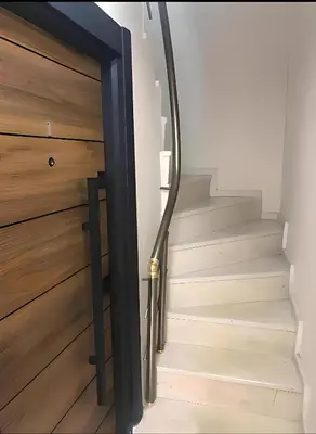 a hallway with a wooden door and stairs at BlueRoyal Grand Bazaar in Istanbul