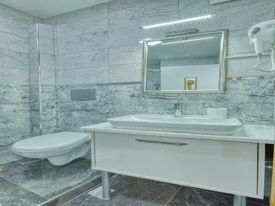 a bathroom with a sink and a toilet and a mirror at GALATAGREENAPPLEHOTEL in Istanbul