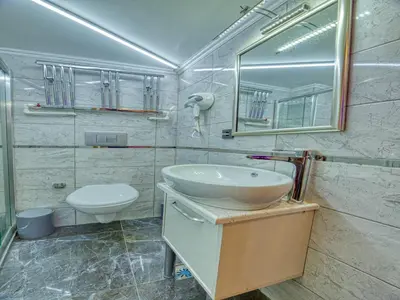 a bathroom with a sink and a toilet and a mirror at GALATAGREENAPPLEHOTEL in Istanbul