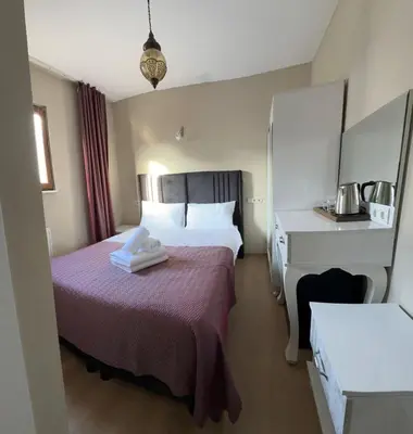 a hotel room with two beds and a desk at Hagia Irene Old City in Istanbul