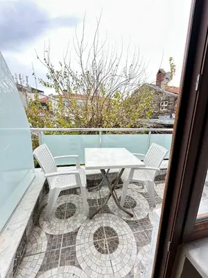 a patio with a table and chairs on a balcony at Hagia Irene Old City in Istanbul