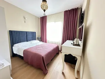 a hotel room with a bed and a window at Hagia Irene Old City in Istanbul
