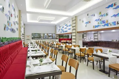 a dining room with tables and chairs in a restaurant at Rox Hotel Istanbul in Istanbul