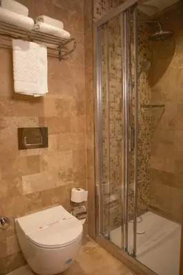 a bathroom with a toilet and a shower at VillaQua Boutique Hotel in Sile