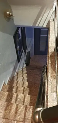 a staircase in a building with a tv on the wall at BOLCELLO HOTEl in Istanbul