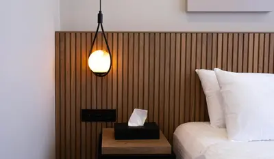 a bedroom with a bed and a lamp and a table at BeL LETTO HOTEL in Istanbul