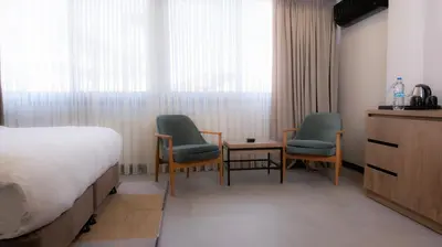 a hotel room with two chairs and a bed at BeL LETTO HOTEL in Istanbul