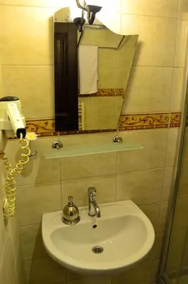 a bathroom with a sink and a mirror at Hotel Alp Guesthouse in Istanbul
