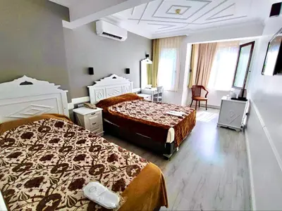 a hotel room with two beds in a room at Hotel Alp Guesthouse in Istanbul