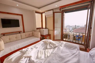 a living room with a couch and a large window at Sabina Hotel near Grand Bazaar, city center in Istanbul