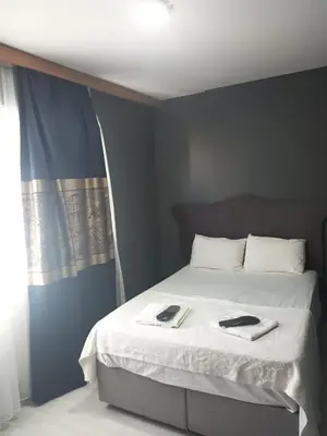 a bedroom with a bed with two towels on it at Rena Apart Hotel in Istanbul