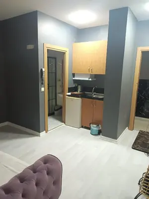 an empty room with a kitchen and a couch at Rena Apart Hotel in Istanbul