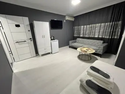 a living room with a couch and a table at Rena Apart Hotel in Istanbul