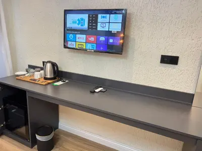 a desk in a room with a tv on the wall at Feycem Suites Hotel in Istanbul