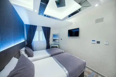 a hotel room with two beds and a skylight at Parmada Hotel in Istanbul