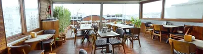 a restaurant with tables and chairs in a room with windows at Parmada Hotel in Istanbul