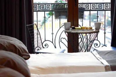 a bedroom with a bed and a table with a tray of food at Parmada Hotel in Istanbul