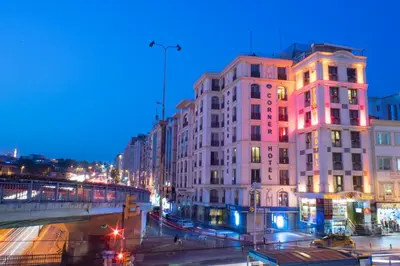 a city street at night with buildings and cars at Parmada Hotel in Istanbul