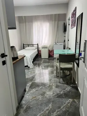 a room with a bed and a desk and a table at Zerya suites in Istanbul