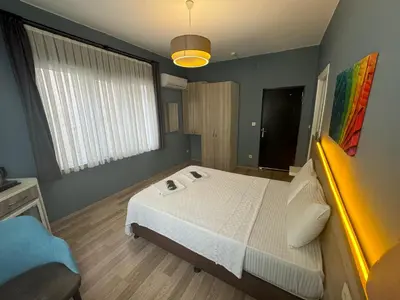 a bedroom with a white bed and a large window at Armoni City Otel Kadıköy in Istanbul