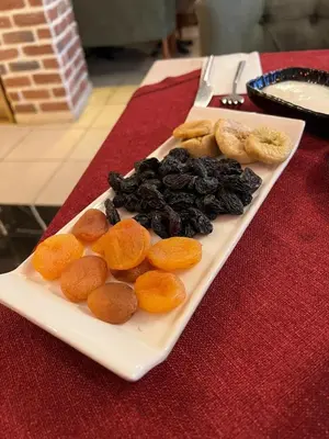 a white plate of food on a red table at SULTAN SÜLEYMAN APART HOTEL in Istanbul
