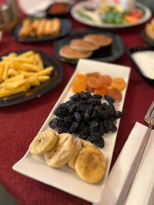 a plate of fruit and vegetables on a table at SULTAN SÜLEYMAN APART HOTEL in Istanbul