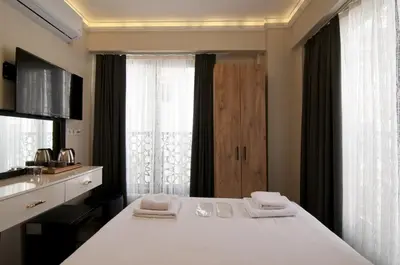 a bedroom with a bed with two towels on it at SULTAN SÜLEYMAN APART HOTEL in Istanbul