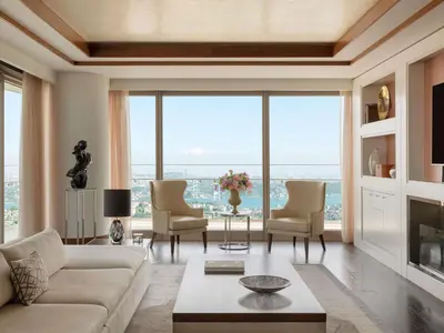 a living room with a couch and chairs and windows at Raffles Istanbul in Istanbul