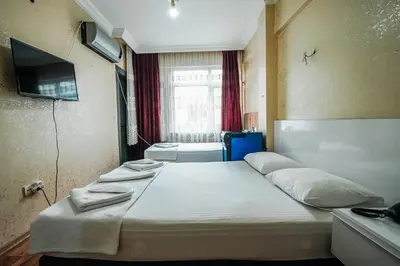 a bedroom with a large bed in a room at SAHRA OTEL in Istanbul