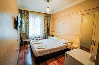 a hotel room with two beds and a mirror at SAHRA OTEL in Istanbul