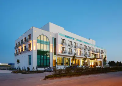 a large white building with a lot of windows at Hattusa Vacation Business Thermal Hotel Saray in Saray