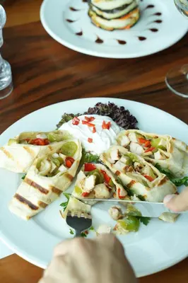 two plates of food on a table with a plate of food at Hattusa Vacation Business Thermal Hotel Saray in Saray