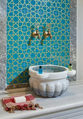 a bathroom with a toilet and a blue wall at Hattusa Vacation Business Thermal Hotel Saray in Saray