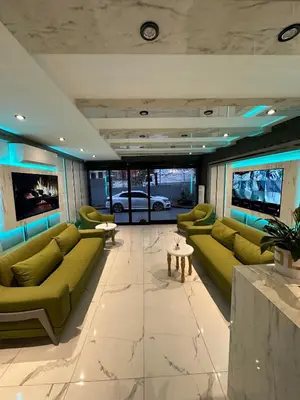 a living room with green couches and a table at gazelle suites in Istanbul