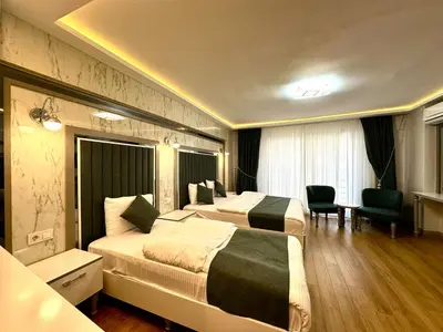 a hotel room with two beds and a desk at gazelle suites in Istanbul