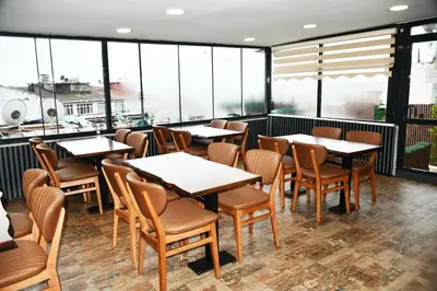 a restaurant with tables and chairs and windows at Leyenda Boutıque Hotel in Istanbul