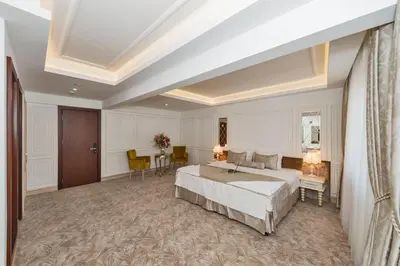 a bedroom with a bed and a table and chairs at Escardin hotel in Istanbul
