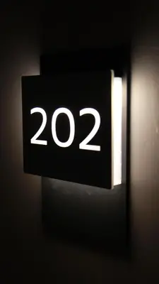a black sign with the number on a wall at Sabiha Sultan Hotel-Karakoy in Istanbul