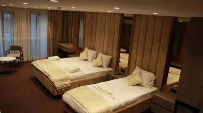 a hotel room with two beds and a mirror at Sabiha Sultan Hotel-Karakoy in Istanbul