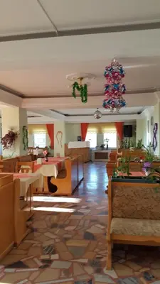 a restaurant with tables and chairs and a christmas tree at SANCAK HOTEL in Buyukcekmece