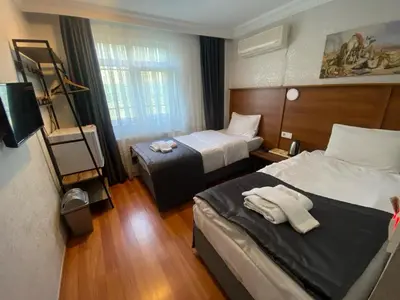a hotel room with two beds and a window at Timex Suites in Istanbul
